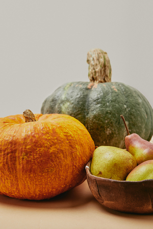close up of autumnal harvest with pumpkins and ripe yummy pears on tableの写真素材