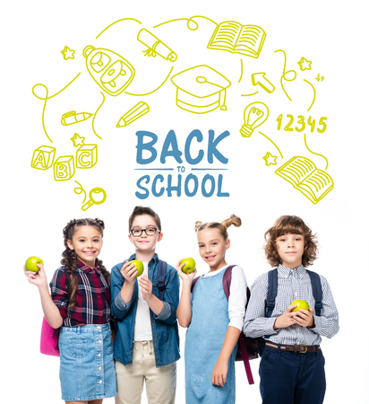 smiling schoolchildren holding ripe apples isolated on white, with icons and "back to school" letteringの写真素材