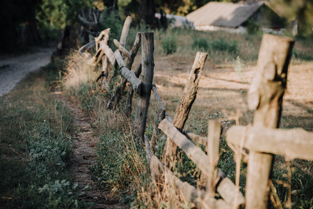 selective focus of wooden fence on meadow in countrysideの写真素材