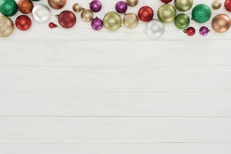 beautiful shiny colorful christmas balls on white wooden backgroundの写真素材