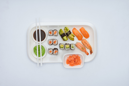 top view of gourmet sushi set with chopsticks isolated on whiteの写真素材