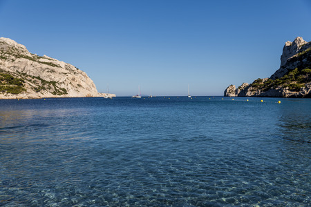 yachts and boats in calm sea harbour and scenic cliffs, Calanques de Marseille (Massif des Calanques), provence, franceの写真素材