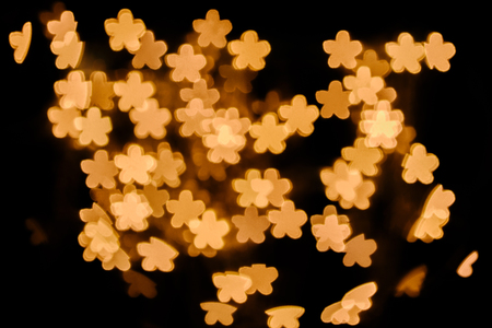 full frame of golden stars bokeh lights on black backgroundの写真素材