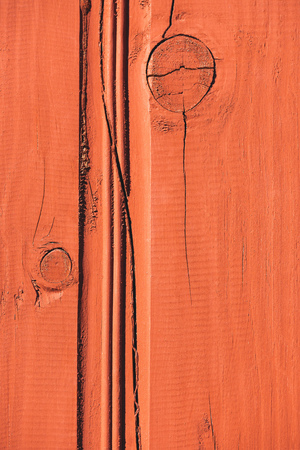 close up of orange wooden fence with cracksの写真素材
