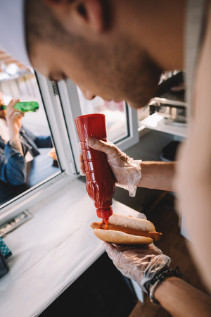 chef preparing hod dog in food truckの写真素材