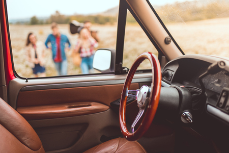 car interior with people walking by flower field during car trip blurred on backgroundの写真素材