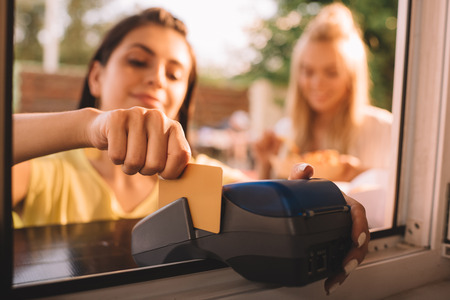 selective focus of customer paying with credit card at food truckの写真素材