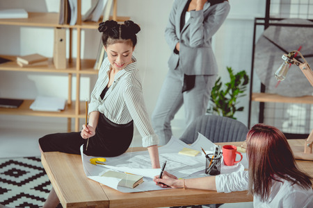 young multiethnic designers in formal wear working at officeの写真素材