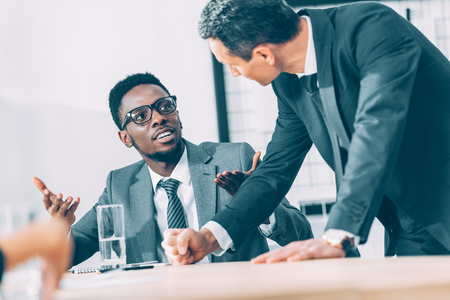 multiethnic businessmen having conversation at officeの写真素材