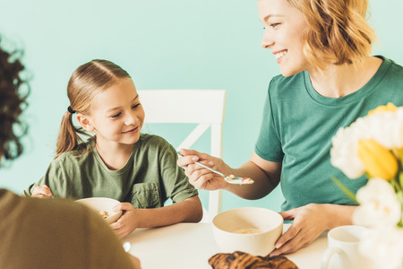 cropped shot of family with cute little daughter having breakfast togetherの写真素材