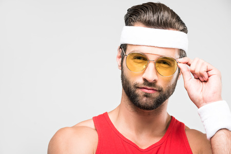 portrait of sportsman in retro sunglasses and sportswear, isolated on white