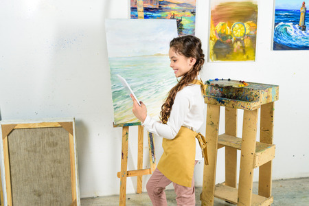 side view of kid using tablet in workshop of art schoolの写真素材