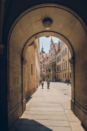 PRAGUE, CZECH REPUBLIC - JULY 23, 2018: archway and people walking on street in old town, prague,...