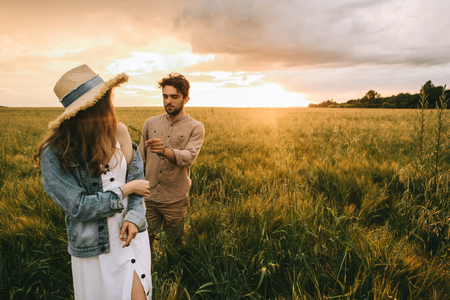 elegant couple walking on meadow tendernessの写真素材