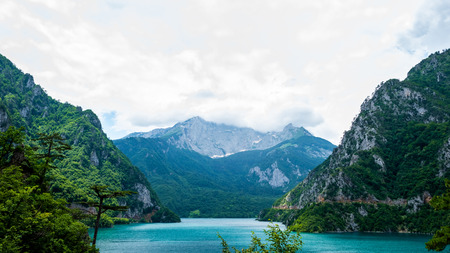 beautiful Piva Lake, mountains and cloudy sky in Montenegroの写真素材
