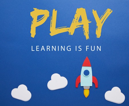 clouds and rocket on blue paper background with play - lettering is fun lettering