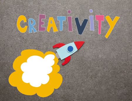 colorful handmade rocket on gray background with "creativity" inspirationの写真素材