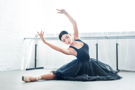 beautiful young ballerina performing ballet in studio