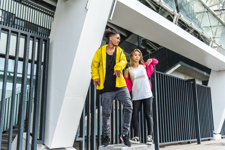 young multiethnic couple dancing at city street