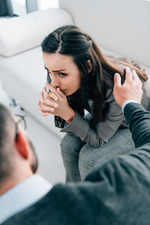 cropped image of psychologist touching shoulder of crying patient in doctors officeの写真素材