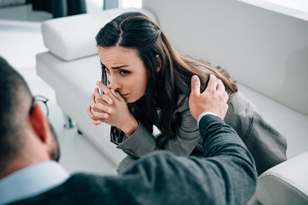 cropped image of psychologist touching shoulder of crying patient in doctors officeの写真素材