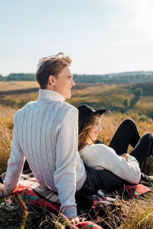young couple looking away on rural meadowの写真素材