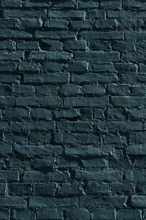 full frame view of black grunge brick wall backgroundの写真素材