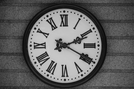 close-up view of old antique clock on grey wall