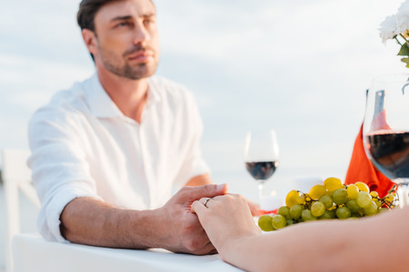 young couple holding hands after propose in romantic dateの写真素材