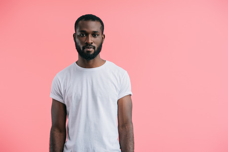 portrait of african american man in white shirt isolated on pink