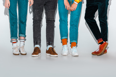low section view of stylish hipsters legs on greyの写真素材