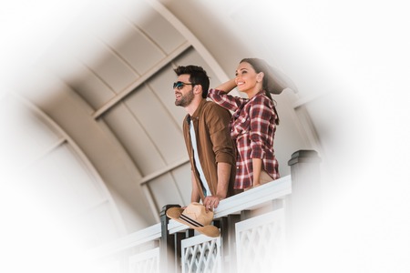smiling cowboy and cowgirl watching horse races at ranch stadiumの写真素材