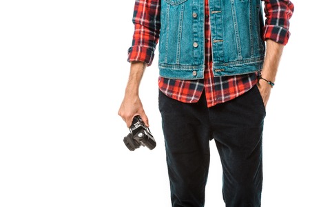 cropped image of hipster male photographer in denim vest and checkered shirt holding camera isolated on whiteの写真素材
