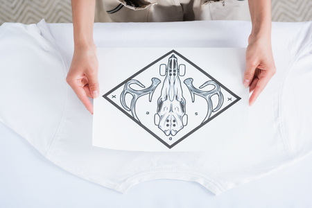 cropped image of female fashion designer choosing print for empty white t-shirtの写真素材