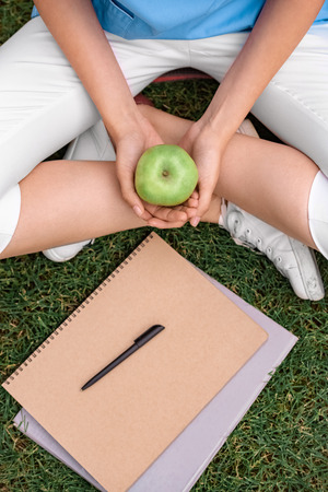 cropped image of medical student holding apple in handsの写真素材