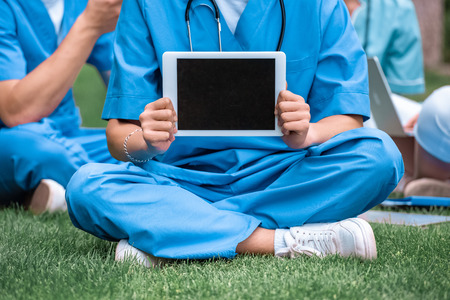 cropped image of medical student holding tablet with blank screenの写真素材