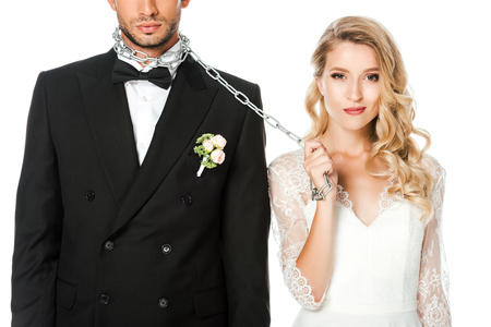 smiling young bride with chain and leashed groom isolated on whiteの写真素材