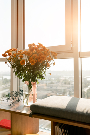 close up view of beautiful bouquet of flowers standing at windowの写真素材