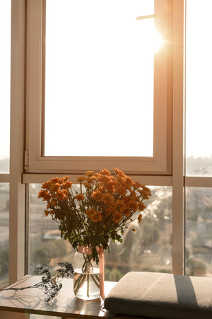 close up view of beautiful bouquet of flowers standing at windowの写真素材