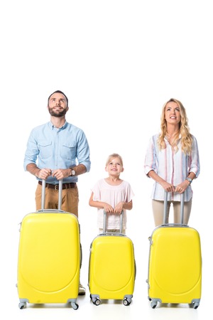 family with yellow travel bags looking up isolated on whiteの写真素材