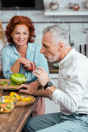 mature couple having salad for dinner at homeの写真素材