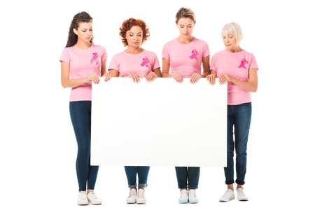 women in pink t-shirts with breast cancer awareness ribbons holding blank banner isolated on whiteの写真素材