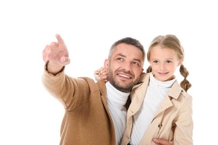 smiling father showing something to daughter in autumn outfit, isolated on whiteの写真素材