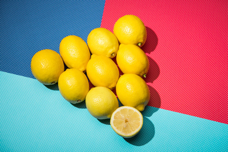 lemons in triangle figure on blue, turquoise and pink background