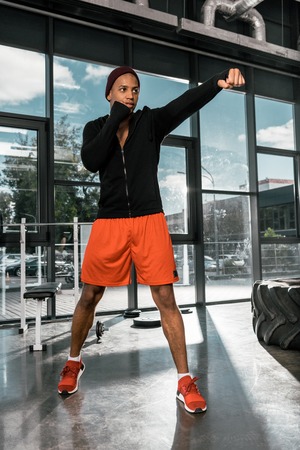low angle view of young african american boxer exercising at gym
