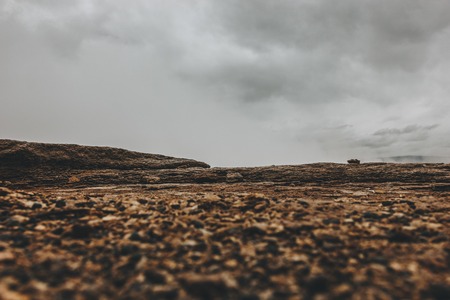 surface level of landscape with cloudy sky in Icelandの写真素材