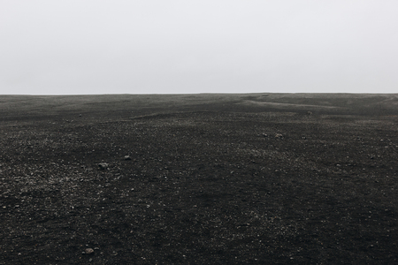 full frame image of black sand beach against cloudy sky in Solheimasandur, Icelandの写真素材