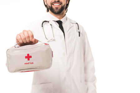 cropped shot of smiling doctor holding first aid kit isolated on whiteの写真素材