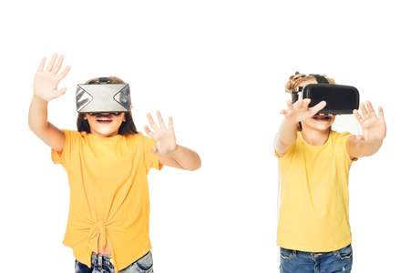 adorable happy kids using virtual reality headsets isolated on whiteの写真素材