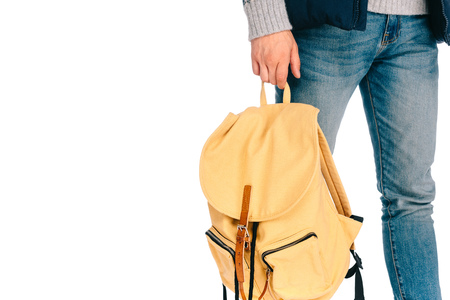 cropped shot of young traveler holding backpack isolated on white